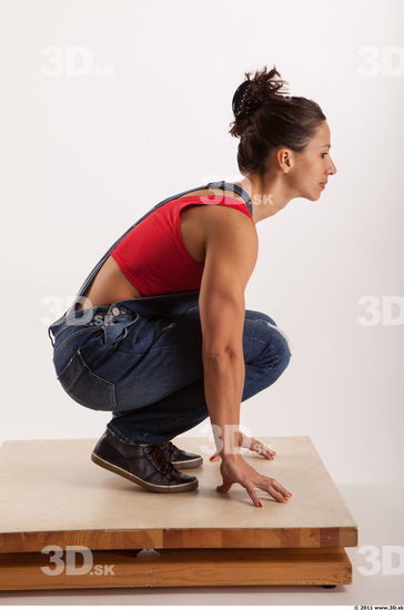 Kneeling pose blue jeans red singlet of Rebecca