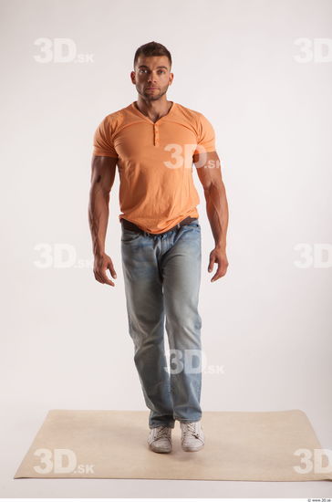 Walking pose orange thsirt light blue jeans of bodybuilder Harold