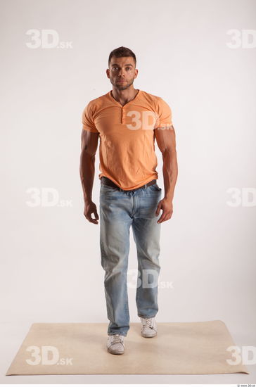 Walking pose orange thsirt light blue jeans of bodybuilder Harold