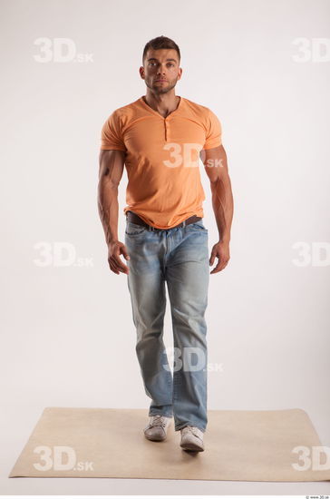 Walking pose orange thsirt light blue jeans of bodybuilder Harold