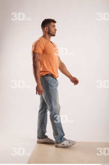 Walking pose orange thsirt light blue jeans of bodybuilder Harold