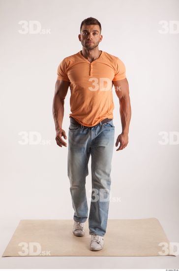 Walking pose orange thsirt light blue jeans of bodybuilder Harold