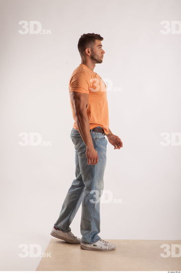 Walking pose orange thsirt light blue jeans of bodybuilder Harold