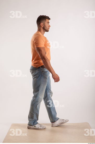 Walking pose orange thsirt light blue jeans of bodybuilder Harold