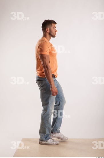 Walking pose orange thsirt light blue jeans of bodybuilder Harold