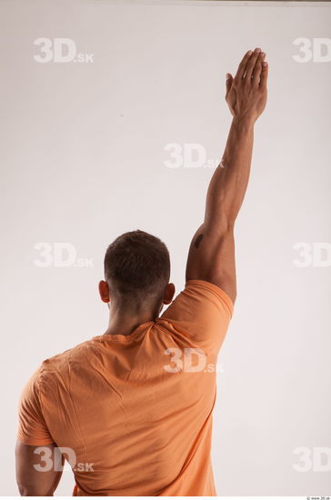 Arm moving pose orange thsirt of bodybuilder Harold