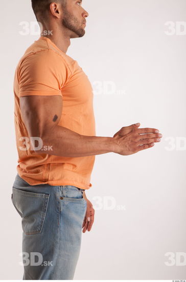 Arm moving pose orange thsirt of bodybuilder Harold