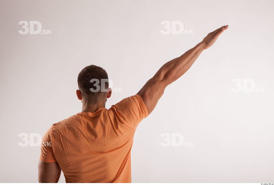 Arm moving pose orange thsirt of bodybuilder Harold