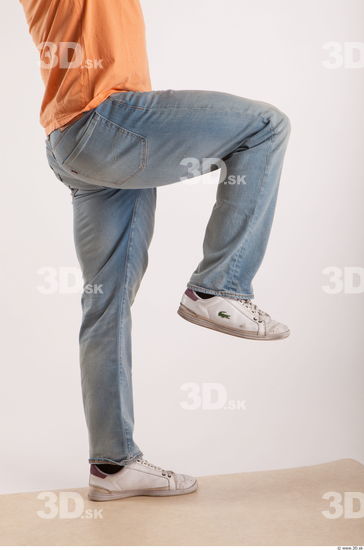 Leg moving pose light blue jeans of bodybuilder Harold