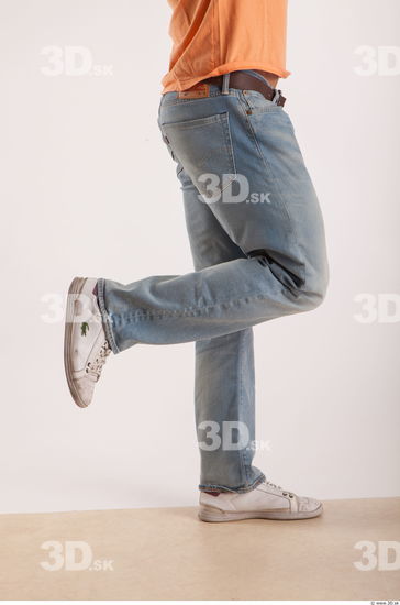 Leg moving pose light blue jeans of bodybuilder Harold