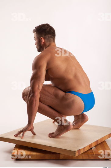 Kneeling pose light of bodybuilder Harold