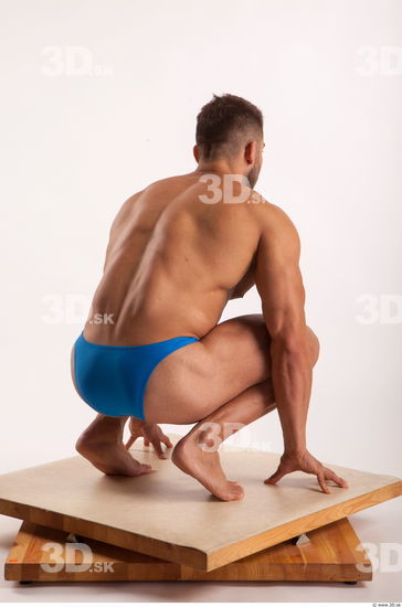 Kneeling pose light of bodybuilder Harold