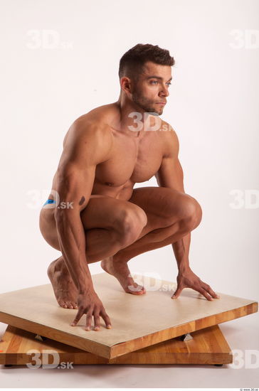 Kneeling pose light of bodybuilder Harold