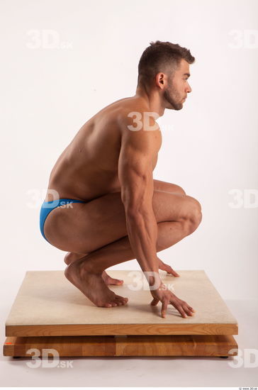 Kneeling pose light of bodybuilder Harold