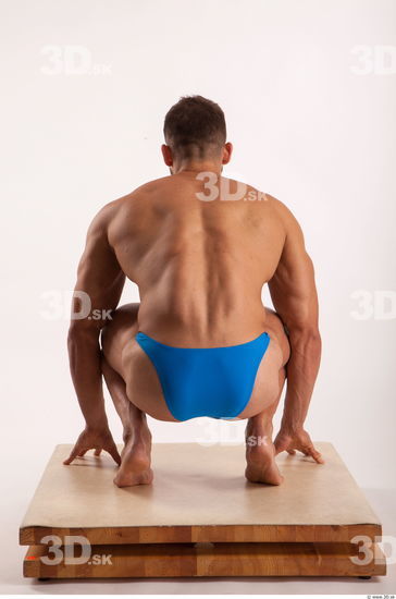 Kneeling pose light of bodybuilder Harold