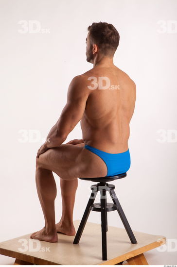 Sitting pose light of bodybuilder Harold