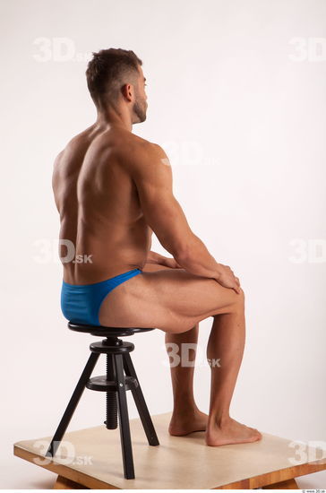 Sitting pose light of bodybuilder Harold