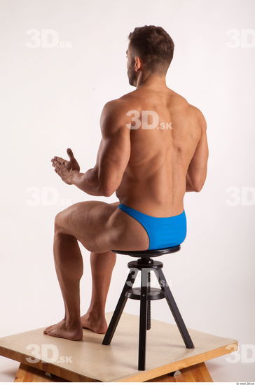 Sitting pose light of bodybuilder Harold