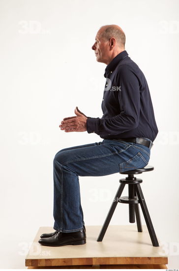 Sitting pose blue deep shirt jeans of Ed