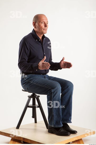 Sitting pose blue deep shirt jeans of Ed