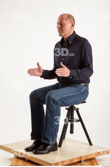 Sitting pose blue deep shirt jeans of Ed