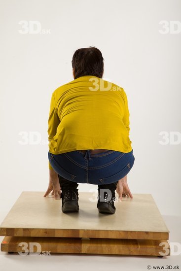 Kneeling reference of yellow sweater blue jeans Gwendolyn