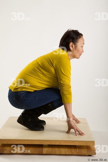 Kneeling reference of yellow sweater blue jeans Gwendolyn