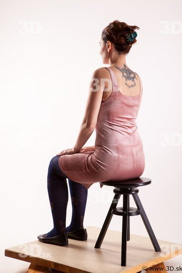 Sitting reference of whole body pink dress purple tights black shoes Nadine