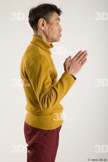 Arm flexing reference of yellow sweater red trousers Sidney