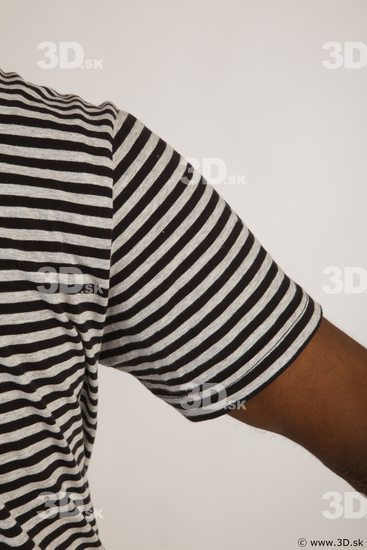 Upper black white striped shirt brown jeans of Arturo