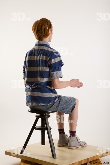 Sitting reference of whole body striped blue gray shirt blue jeans shorts black gray shoes Wesley