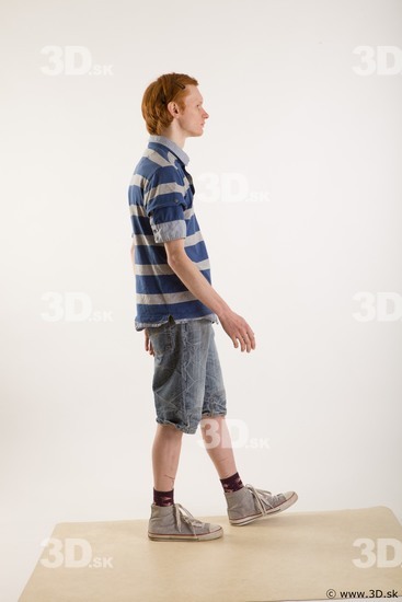 Walking reference of whole body striped blue gray shirt blue jeans shorts black gray shoes Wesley