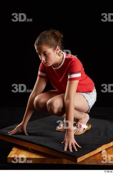 Whole Body Woman White Shirt Jeans Shorts Average Kneeling Studio photo references