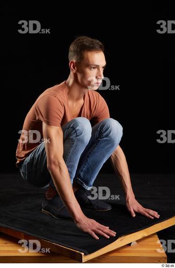 Alessandro Katz  black shoes blue jeans brown t shirt casual dressed kneeling whole body  jpg