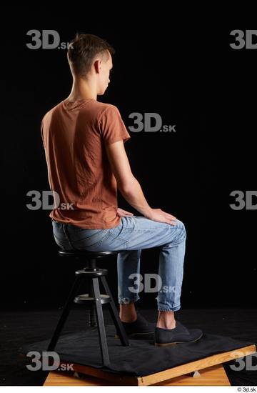 Alessandro Katz  black shoes blue jeans brown t shirt casual dressed sitting whole body  jpg