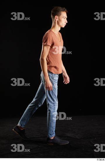 Alessandro Katz  black shoes blue jeans brown t shirt casual dressed side view walking whole body  jpg