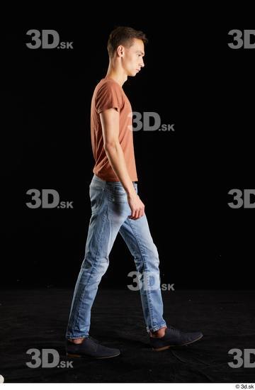 Alessandro Katz  black shoes blue jeans brown t shirt casual dressed side view walking whole body  jpg