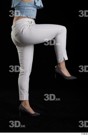 Serina Gomez  casual dressed flexing grey high heels leg side view white trousers  jpg