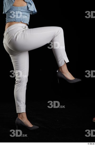 Serina Gomez  casual dressed flexing grey high heels leg side view white trousers  jpg