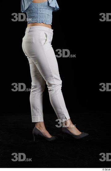 Serina Gomez  casual dressed flexing grey high heels leg side view white trousers  jpg