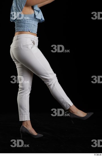 Serina Gomez  casual dressed flexing grey high heels leg side view white trousers  jpg