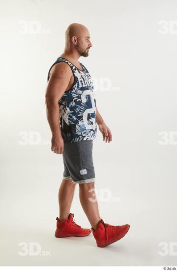 Neeo  blue shorts dressed orange sneakers side view sports tank top walking whole body  jpg