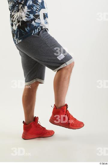 Neeo  blue shorts dressed flexing leg orange sneakers side view sports  jpg