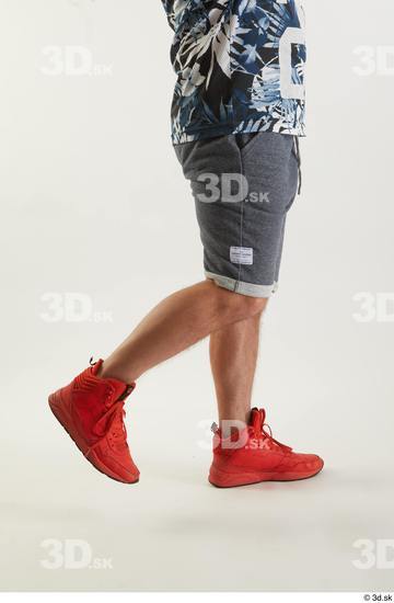 Neeo  blue shorts caf dressed flexing orange sneakers side view sports  jpg