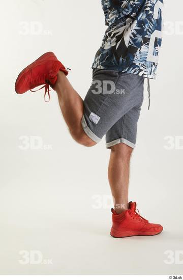 Neeo  blue shorts caf dressed flexing orange sneakers side view sports  jpg