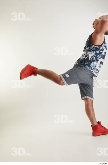 Neeo  blue shorts dressed flexing leg orange sneakers side view sports  jpg