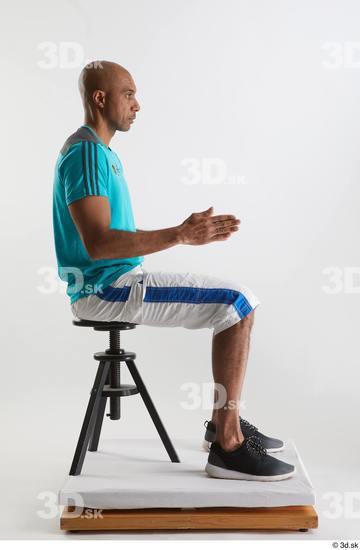 Whole Body Man Black Sports Shirt Shorts Slim Sitting Studio photo references